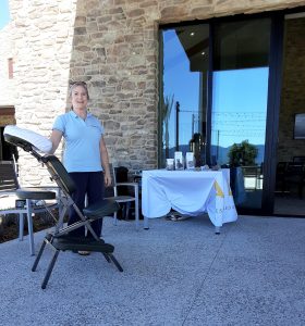 Julia Morrow doing chair massage in 2022 at an outdoor event