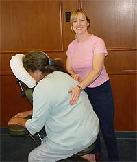 Julia Morrow performing chair massage on woman